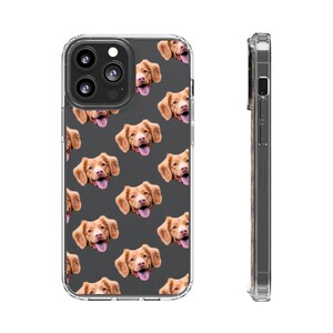 May include: A clear phone case with a repeating pattern of a dog's face. The dog has brown fur and is looking directly at the camera. The case is designed for an iPhone 14 Pro Max.