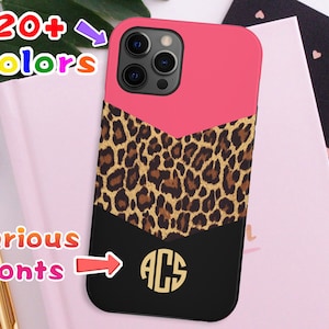May include: A pink, black, and brown phone case with a leopard print design and a monogrammed initial "ACS". The case is compatible with iPhone models.