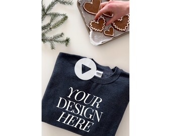 May include: A dark gray sweatshirt with the text "YOUR DESIGN HERE" printed in white on the front. The sweatshirt is folded and lying on a white surface.