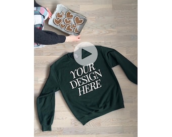 May include: A dark green sweatshirt with the text "YOUR DESIGN HERE" printed in white on the front.