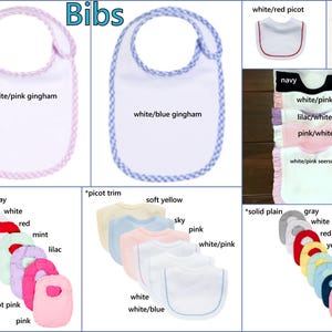 May include: A collection of baby bibs featuring various styles including white with pink or blue gingham trim, solid ruffles in multiple colors, picot trim options, and solid plain designs in shades like gray, white, red, yellow, mint, sky, navy, and pink.