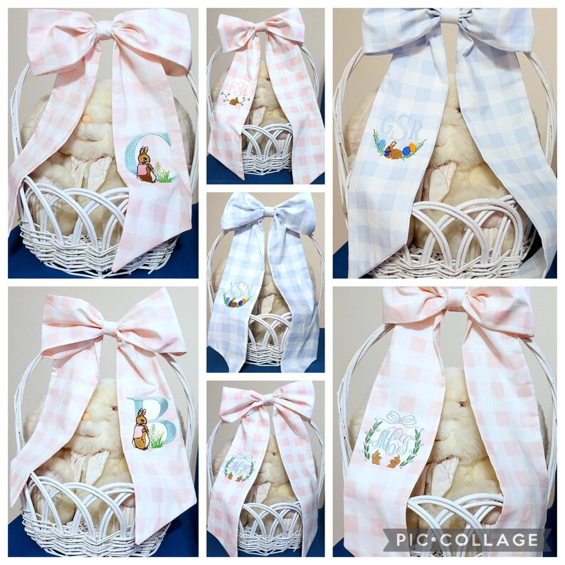 May include: White wicker Easter baskets with plush bunnies, adorned with large gingham bows in pink and blue. Some bows feature embroidered initials, bunnies, and Easter eggs. A charming and festive gift.