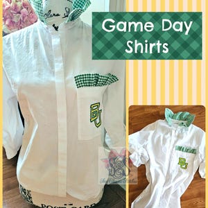 May include: A white button-down shirt featuring a green and white gingham collar and pocket trim. The pocket displays the letters BU in green with a yellow outline. The text Game Day Shirts is visible in a green box with a white gingham pattern.