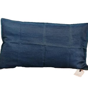 May include: A blue rectangular cushion with a subtle sheen. The cushion is made of a soft, textured fabric.