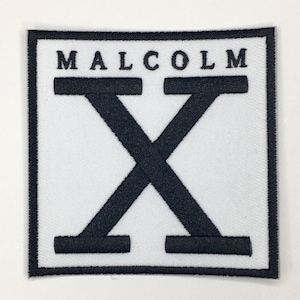 May include: Black and white embroidered patch with the text "MALCOLM X" inside a square frame.