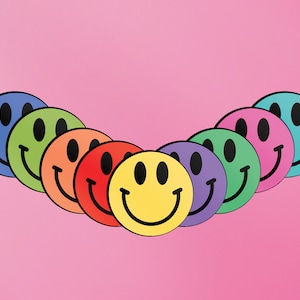 May include: A row of eight colourful smiley face stickers arranged in a semi-circle on a pink background.