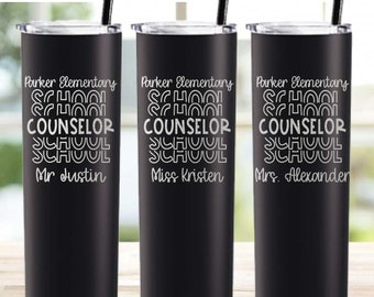 May include: Three black stainless steel tumblers with a white design. The tumblers are engraved with the text "Parker Elementary School Counselor" and the names "Mr. Justin", "Miss Kristen", and "Mrs. Alexander".