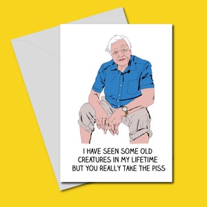 May include: A humorous greeting card featuring a cartoon illustration of a man with white hair and a blue shirt. The text on the card reads "I have seen some old creatures in my lifetime but you really take the piss."