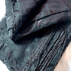 May include: Black sheer scarf with black embroidery and beaded trim.