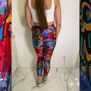May include: Vibrant leggings with a colourful abstract design in shades of red, blue, yellow, and purple. The leggings feature a high waist and a form-fitting silhouette, showcasing a unique and artistic pattern. The leggings are made of a soft, stretchy material.