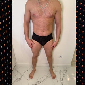 May include: Black underwear with a white polka dot pattern. The underwear is made of a soft, comfortable material. The image shows the underwear on a person.