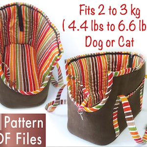 May include: A brown and striped fabric pet carrier with a zipper closure. The carrier has a handle and adjustable shoulder straps. It is designed to fit a small dog or cat weighing between 4.4 and 6.6 pounds. The text on the image reads "Fits 2 to 3 kg (4.4 lbs to 6.6 lbs) Dog or Cat".