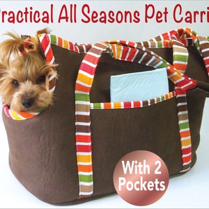 May include: Brown pet carrier with striped fabric trim and two pockets. A small dog is peeking out of the carrier. "With 2 Pockets" is written on a copper-colored circle.