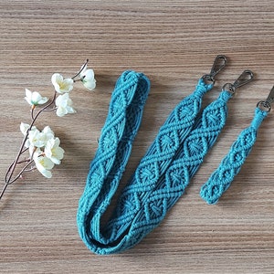 May include: Three teal blue macrame straps with silver metal clasps. The straps are made with a diamond pattern and are different lengths.
