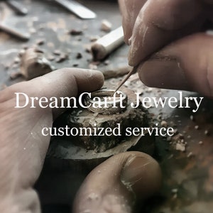 May include: A close-up of a jeweler working on a silver ring. The ring is being held in a metal clamp and the jeweler is using a small tool to shape the metal. The text "DreamCarft Jewelry customized service" is visible in the image.
