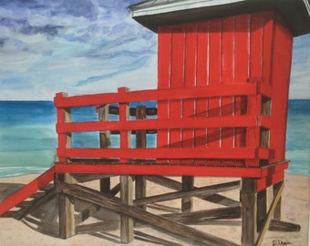 May include: A red lifeguard stand on a beach with a wooden ladder and a wooden platform. The stand is painted red with white trim. The beach is sandy and the water is blue.