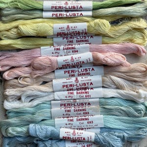 May include: A selection of embroidery floss skeins in various pastel shades, including green, yellow, pink, and blue. Each skein is labelled with "PERI-LUSTA FINE DARNING" and colour details. The floss is 4-ply.