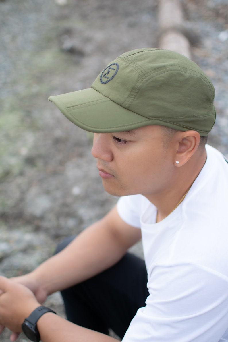 army green cap hat travel hiking commuting running walking techwear gorpcore streetwear water resistant dwr stretchy versal concepts  side model reflective breathable buckle adjustable soft foldable