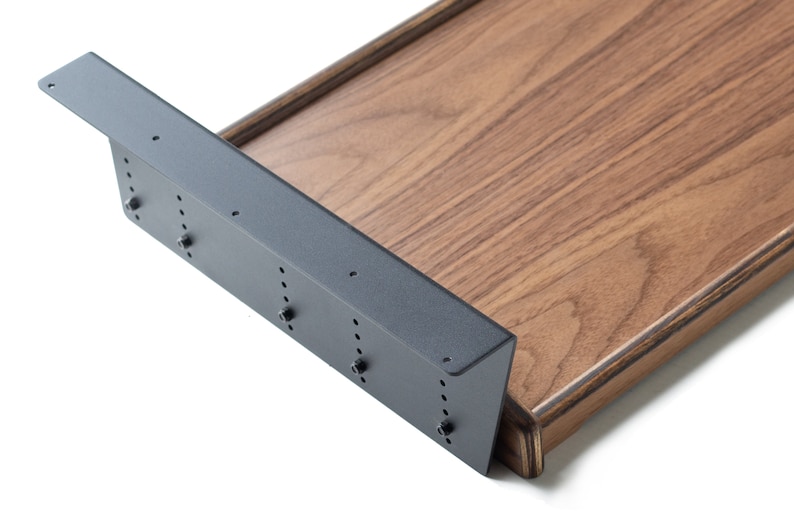 May include: A close-up of a wooden shelf bracket with a black metal support. The bracket is attached to a wooden shelf with screws. The shelf is made of a dark wood with a natural grain.