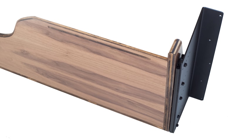 May include: A wooden shelf bracket with a black metal support. The shelf is made of wood with a natural finish. The metal support is attached to the shelf with screws.