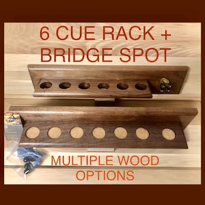 May include: A wooden wall-mounted cue rack with six slots for holding pool cues. The rack also has a bridge spot for practicing pool shots. The text "6 CUE RACK + BRIDGE SPOT" is printed on the top of the rack. The text "MULTIPLE WOOD OPTIONS" is printed below the rack.