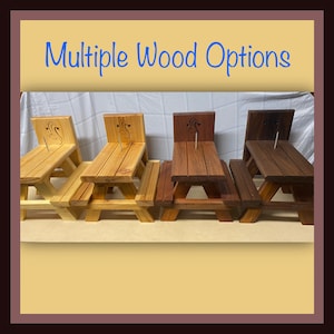 May include: Four miniature wooden picnic tables in different wood stains: natural, light brown, medium brown, and dark brown. The tables are all the same size and have a simple design. "Multiple Wood Options" is written in blue text at the top of the image.