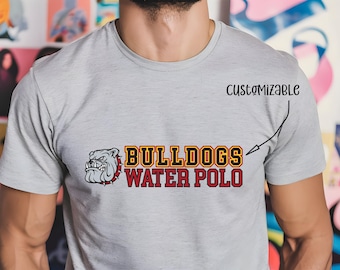 May include: Grey t-shirt with a red and yellow bulldog graphic and the text "Bulldogs Water Polo". The text "Customizable" is written above the graphic.