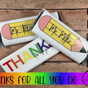 May include: Three printable chocolate bar wrappers with a pencil design. One wrapper says "Thank you for all you do" in rainbow letters. The other two wrappers have a pencil design and say "Mr. Reese" and "Mr. Miller".