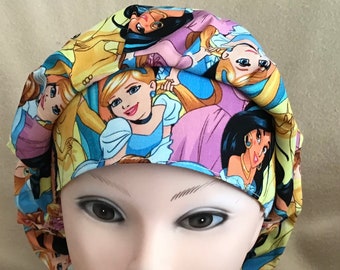 May include: A yellow, blue, and pink surgical scrub hat with a print of various Disney princesses. The hat is made of a soft, comfortable fabric and is designed to be worn by medical professionals.