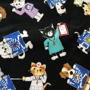 May include: Black fabric with a repeating pattern of cats and dogs dressed as doctors. The animals are holding x-rays and medical equipment.