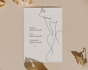 May include: A white card with a line drawing of a face and the text "Respect Begins with self. Love Begins with self. Compassion Begins with self." is surrounded by dried flowers on a beige surface.