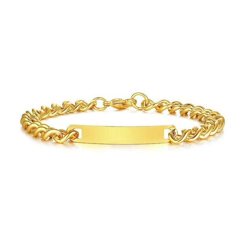 May include: A gold-toned chain link bracelet featuring a central rectangular identification plate with a smooth, polished surface. The bracelet is constructed from interlocking metal links and includes a secure lobster claw clasp closure.
