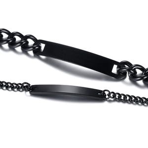 May include: Two black metal bracelets featuring smooth, rectangular identification plates. One bracelet consists of thick, interlocking curb chain links, while the other is composed of a finer, delicate cable chain. Both pieces have a matte finish.