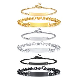 May include: A collection of six metal bracelets arranged in pairs. Each pair includes one thin chain and one thicker curb chain, each featuring a central rectangular identification plate. The set includes gold, silver, and black colored metal finishes.