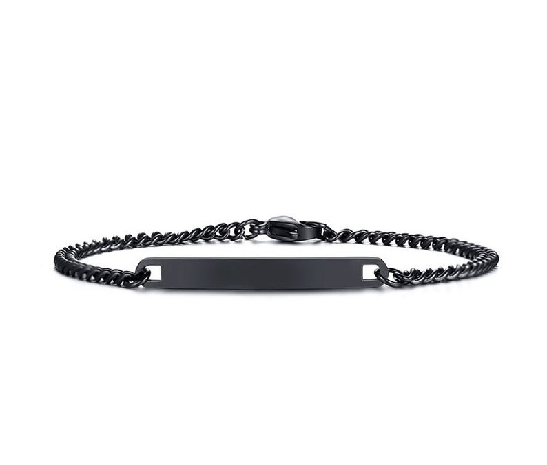 May include: A matte black metal ID bracelet featuring a flat, rectangular identification plate centered on a delicate curb chain. The bracelet is secured with a matching black lobster claw clasp, presenting a uniform dark finish throughout the design.