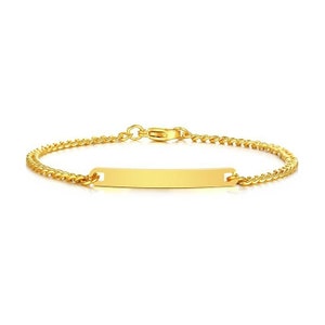 May include: A gold-toned chain bracelet featuring a central, smooth, rectangular identification plate. The bracelet is constructed with a delicate curb chain link design and includes a secure lobster claw clasp mechanism at the back.