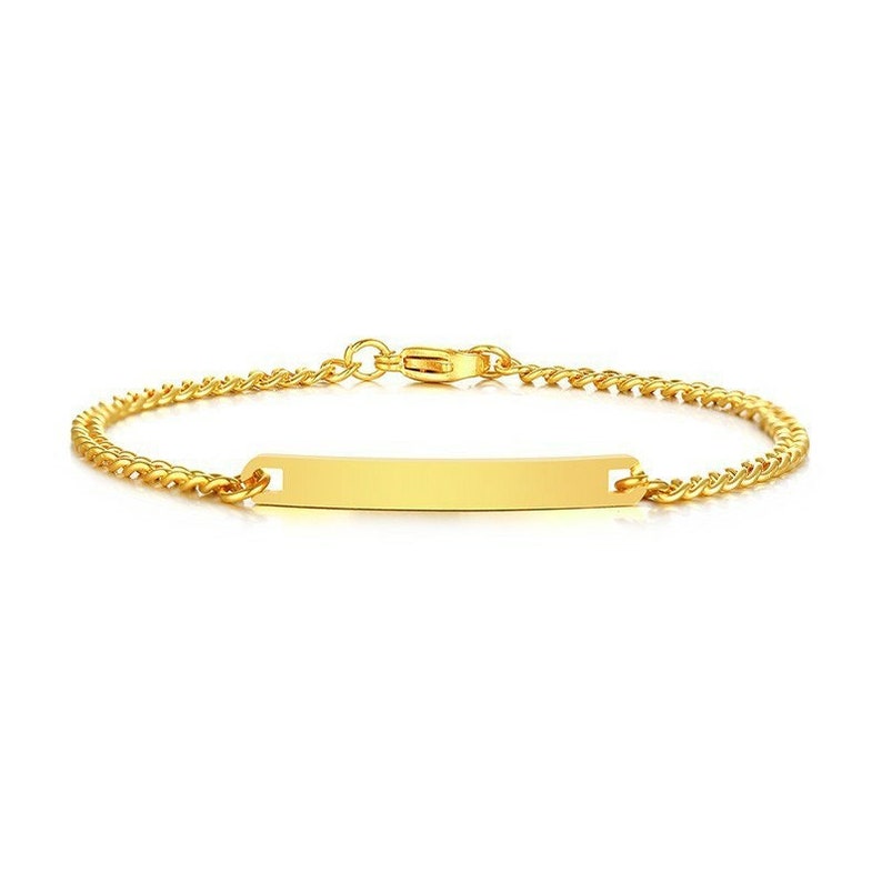 May include: A gold-toned chain bracelet featuring a central, smooth, rectangular identification plate. The bracelet is constructed with a delicate curb chain link design and includes a secure lobster claw clasp mechanism at the back.