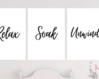 May include: Three white framed prints with black calligraphy. The prints read "Relax", "Soak", and "Unwind".