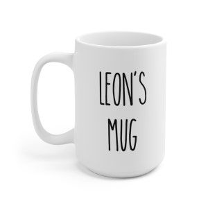 May include: White ceramic mug with black text that reads "LEON'S MUG".