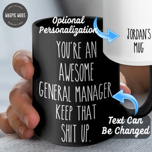 May include: Black coffee mug with white text that reads "You're an awesome general manager keep that shit up." The text "Jordan's Mug" is visible on the white mug in the background. The text on the black mug can be changed.