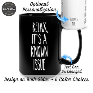 May include: Black ceramic coffee mug with white text that reads "Relax, It's a Known Issue". The mug has a white handle and the text "Jordan's Mug" is visible on the side of the mug. The text "Text Can Be Changed" is visible below the mug.