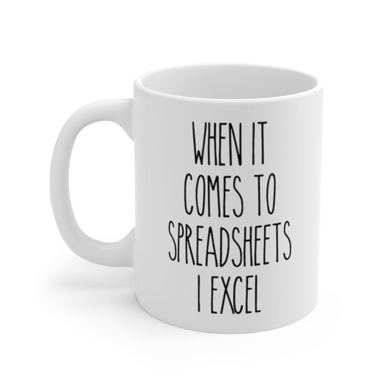 May include: White ceramic coffee mug with black text that reads "When it comes to spreadsheets I excel".
