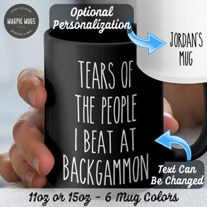 May include: Black ceramic mug with white text that reads "Tears of the people I beat at backgammon". The mug is 11oz or 15oz and comes in 6 colors. The text can be personalized.