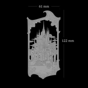 May include: A silver metal cutout of a detailed castle with a gothic design. The castle is surrounded by a decorative frame. The cutout measures 6.1 inches wide and 4.8 inches tall.