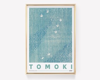 May include: A framed print of a blue and white Japanese woodblock print with the text "TOMOKI WOODBLOCK 1869".