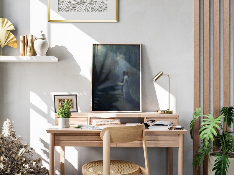 a desk with a chair and a painting on the wall