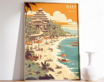 May include: A framed art print of a beach scene in Bali, Indonesia. The artwork features a multi-story building on a hillside, a sandy beach with people, orange umbrellas, and boats on the turquoise water. The sky is orange with white clouds.