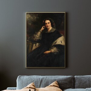 May include: A painting of a woman in a dark blue dress with a white fur shawl. She is sitting in a chair and has a thoughtful expression on her face. The background is a dark forest.