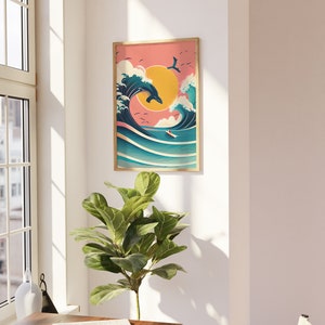 May include: A framed illustration of a blue whale jumping over a large wave with a surfer riding the wave. The background is a pink sunset with a yellow sun.