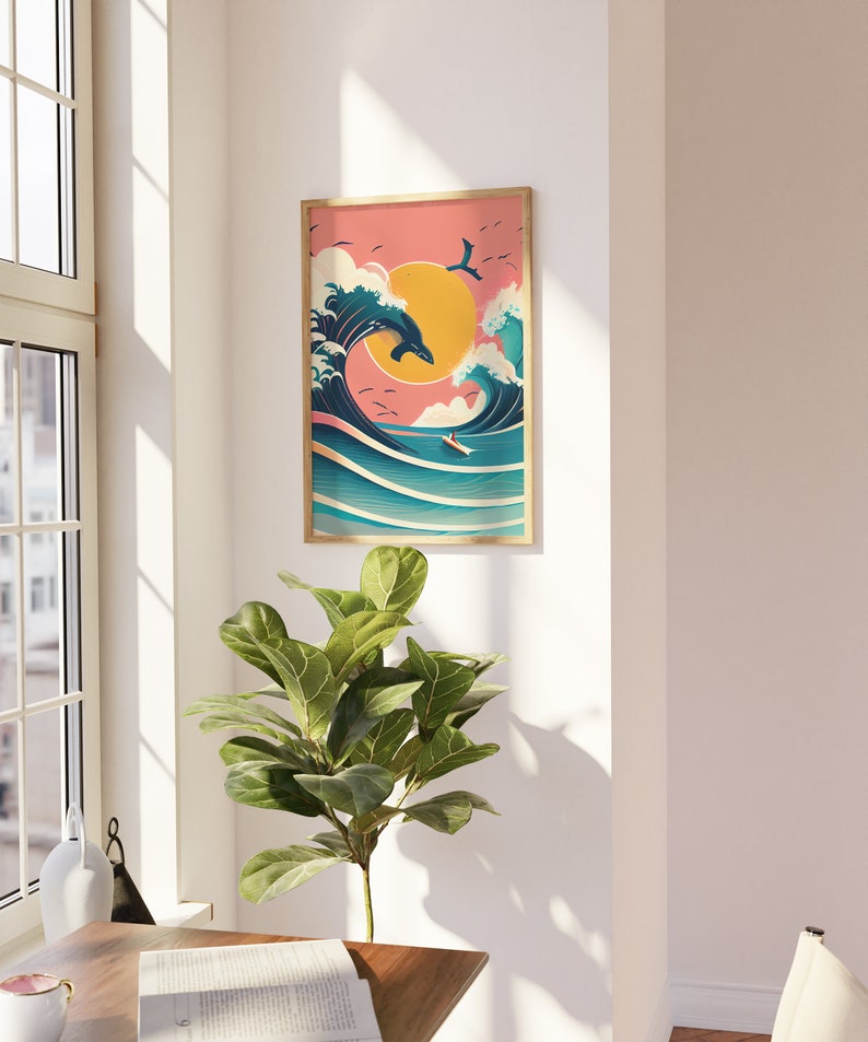 May include: A framed illustration of a blue whale jumping over a large wave with a surfer riding the wave. The background is a pink sunset with a yellow sun.